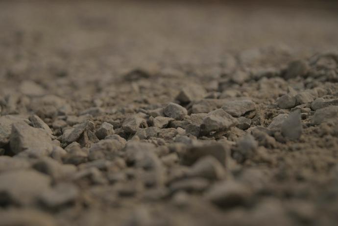 a close up of rocks and gravel with a blurry background